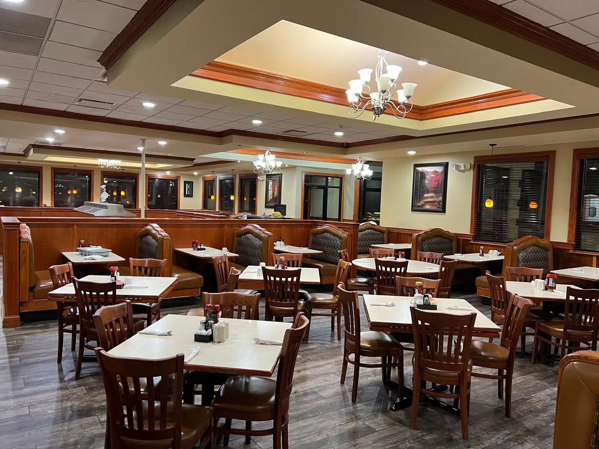 The main dining room with booths, tables and framed art