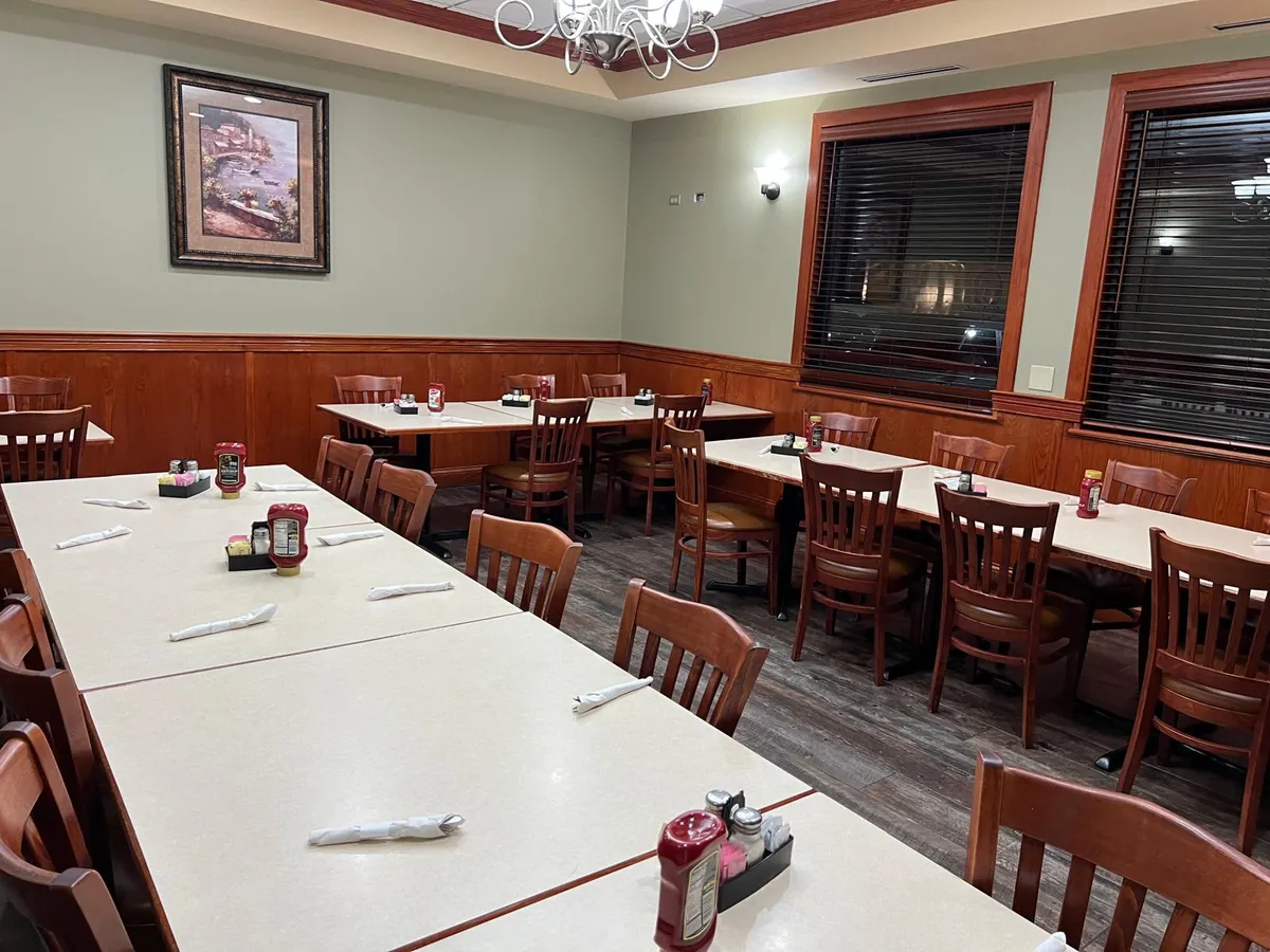 A side dining room with long tables set together for a group